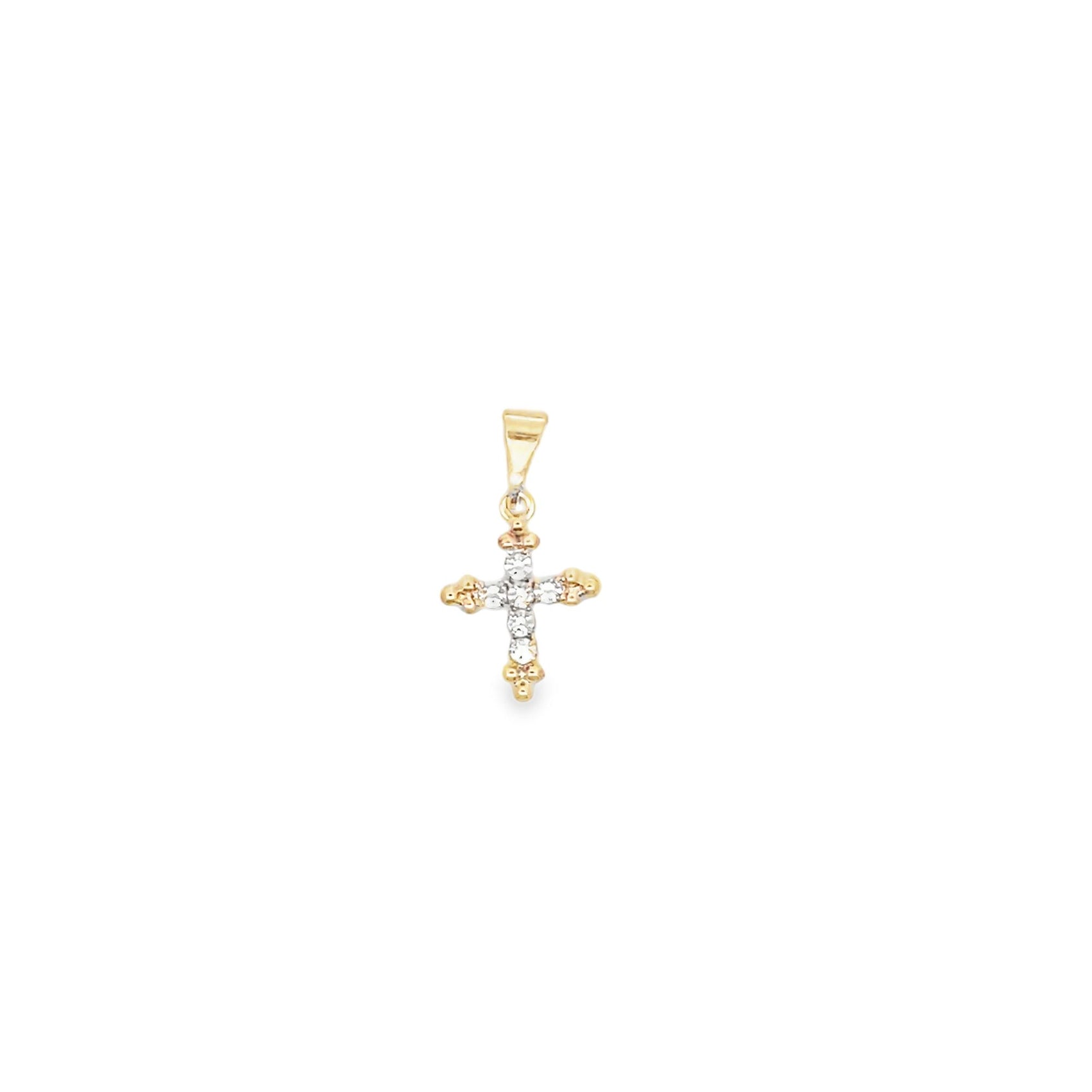 A delicate gold cross pendant features sparkling small diamonds embedded along its center against a plain white background.