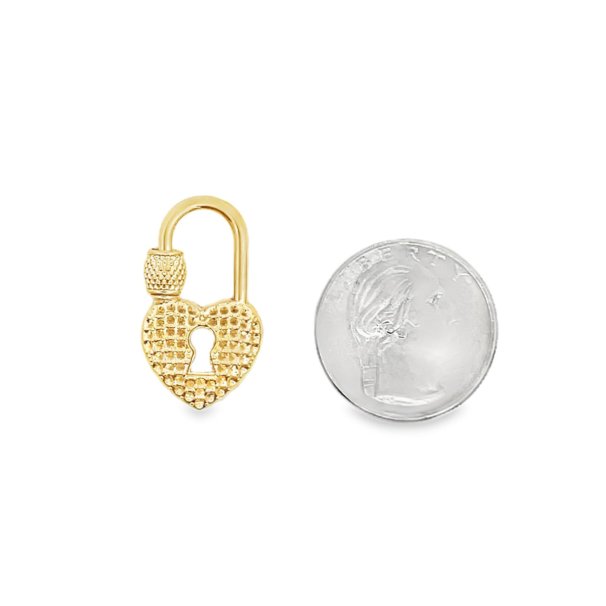 A textured gold heart padlock charm rests beside a US dime for size comparison.