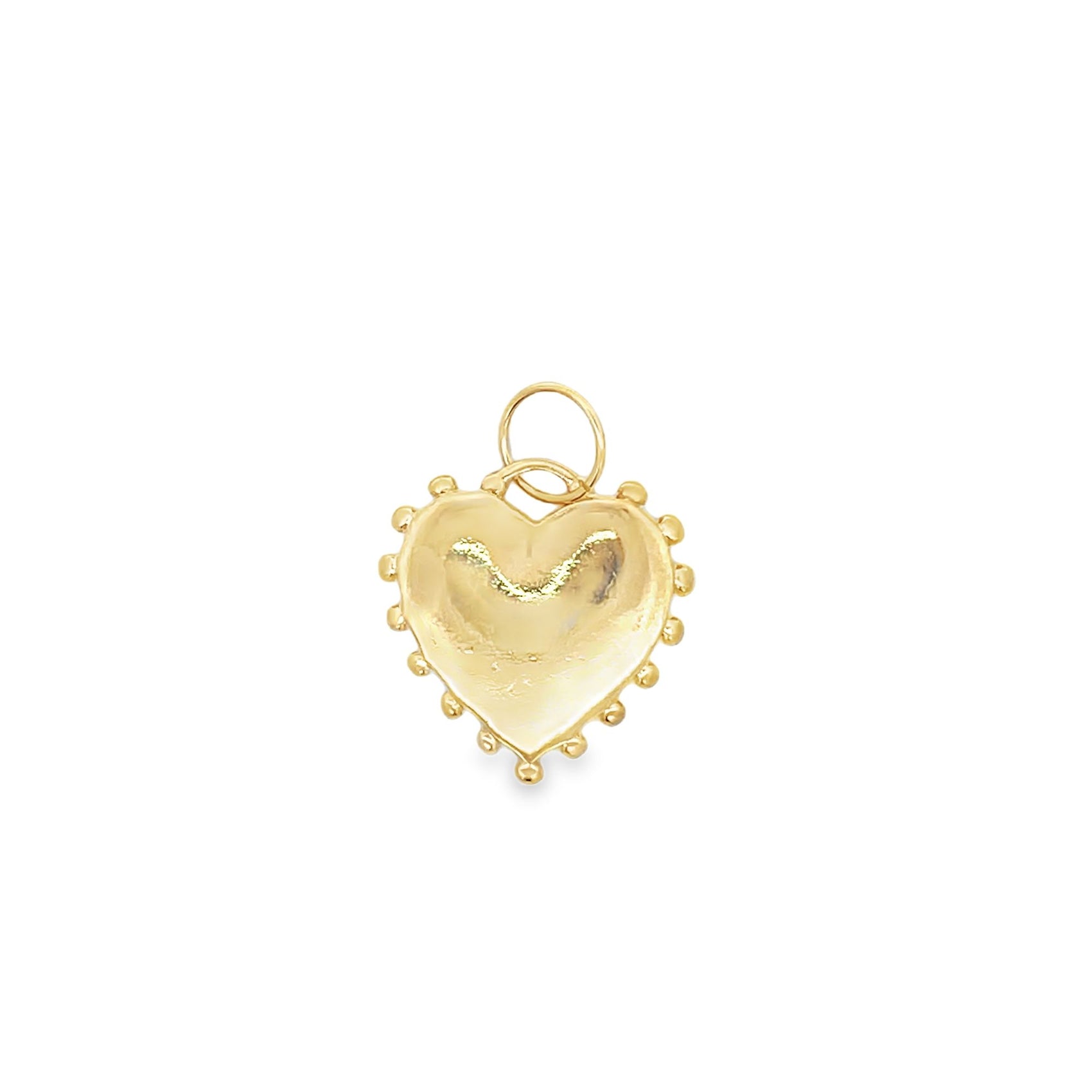 A gold heart-shaped charm features delicate beaded detailing along its scalloped edge.