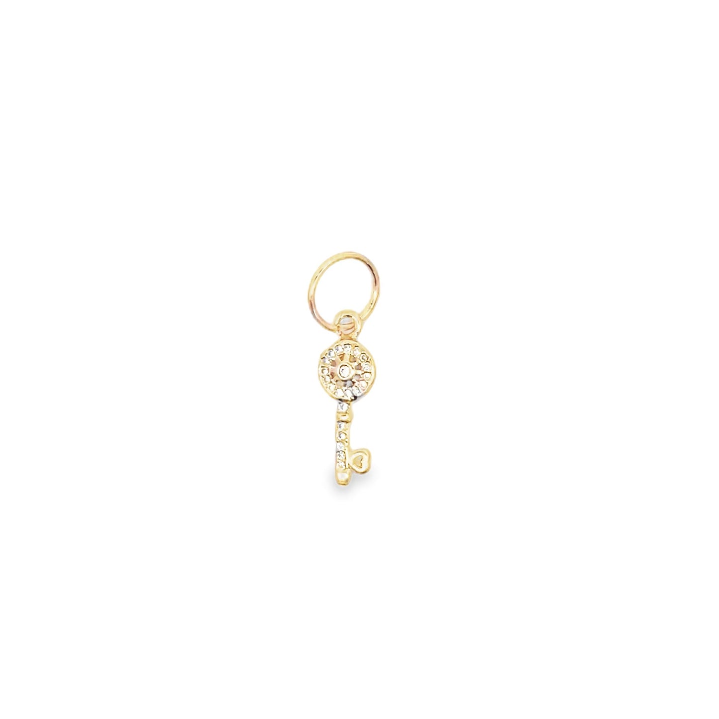 A delicate gold key charm sparkles with embedded crystals against a plain white background.