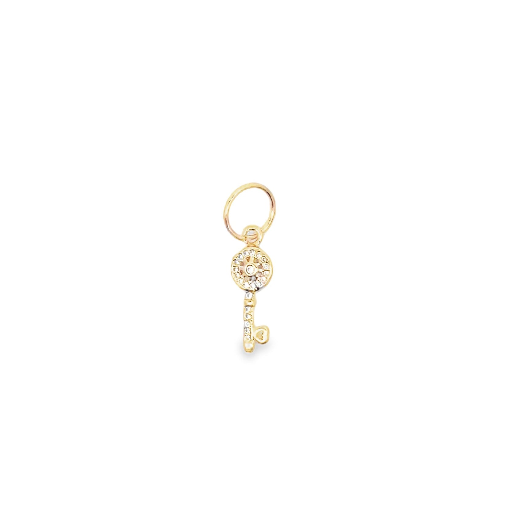 A delicate gold key charm sparkles with embedded crystals against a plain white background.