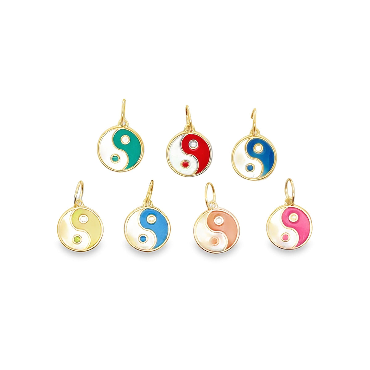 Seven colorful gold enamel yin-yang pendants are arranged against a white background.