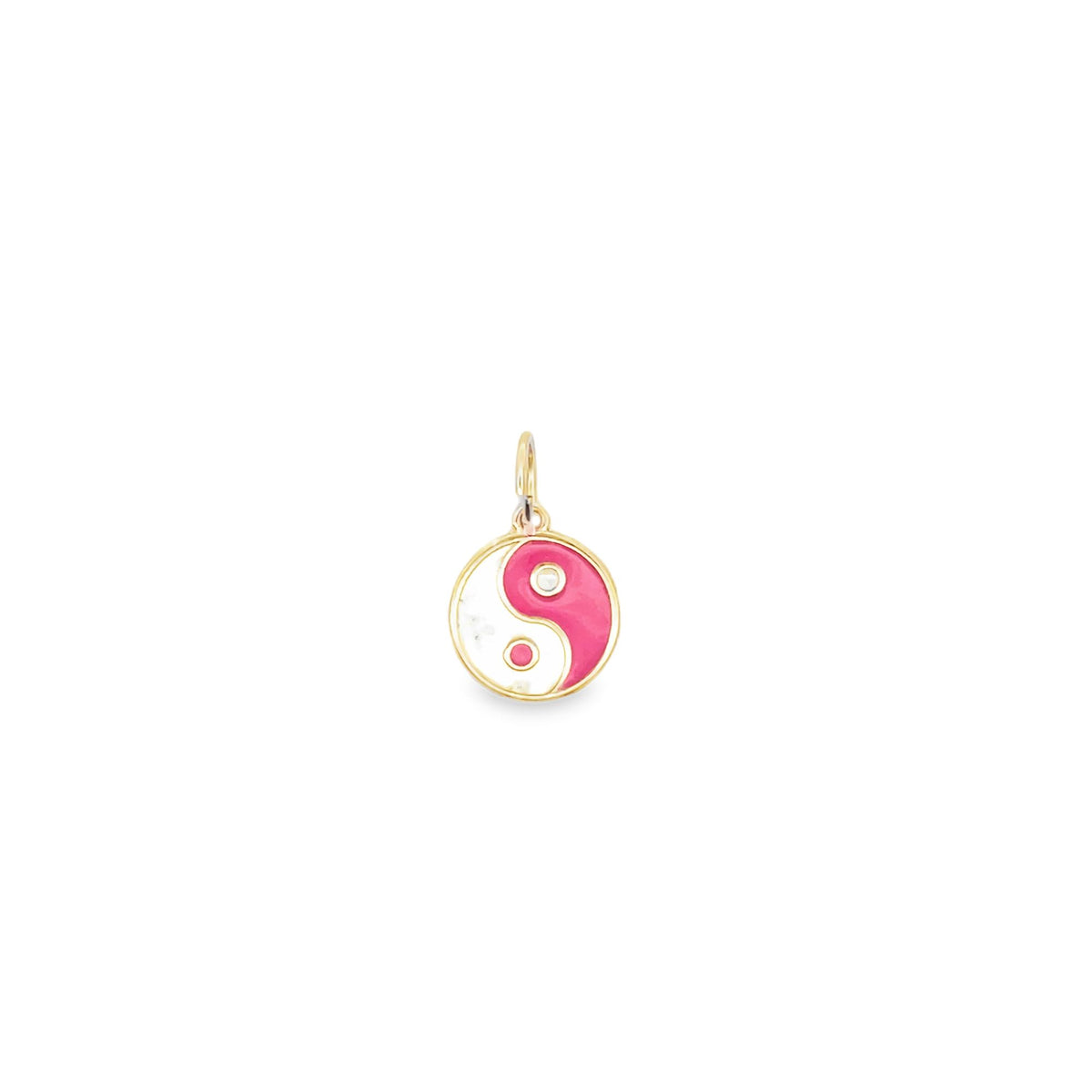 A gold yin-yang charm features pink and white enamel with a small diamond accent.