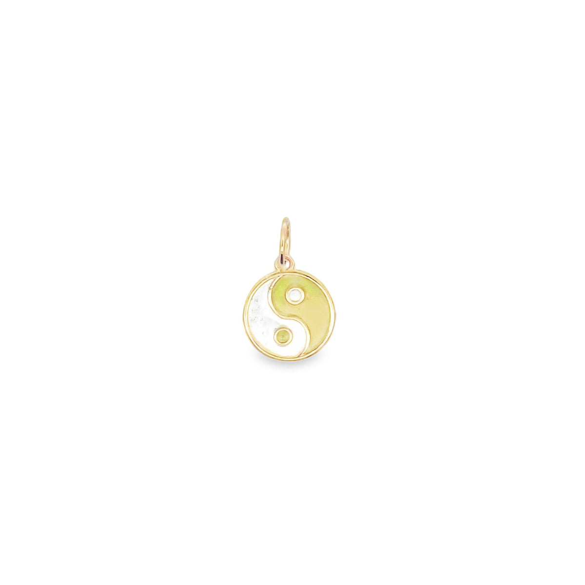 A delicate gold charm features a green and white enamel yin yang symbol against a clean white background.