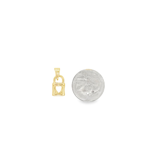 A small gold padlock pendant with a heart cutout rests beside a US dime for size comparison.