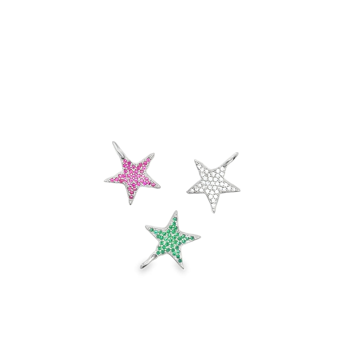 Three star-shaped silver pendants feature pavé settings with pink, green, and white gemstones against a plain white background.