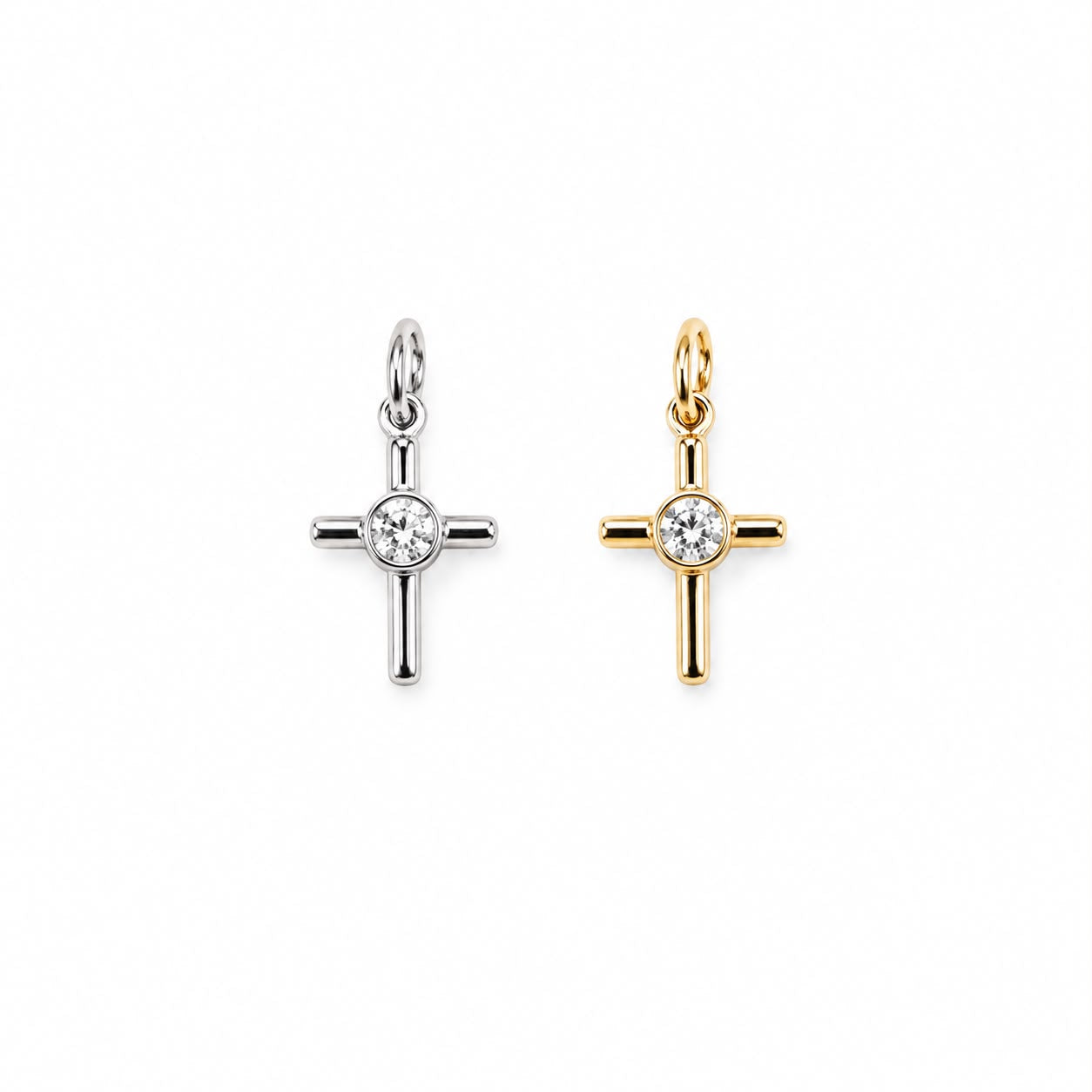 Minimalist cross charm with a bezel-set round cubic zirconia center. Crafted in 18K Gold Filled and Rhodium for necklaces, bracelets, and hoop earrings.