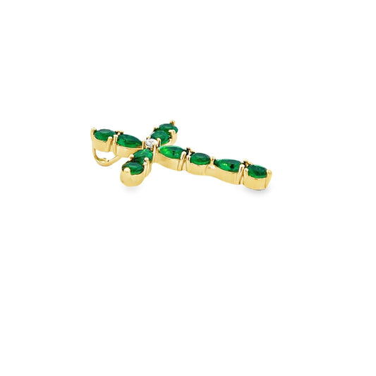A gold cross pendant features sparkling green emerald gemstones set along its arms with a central diamond accent against a plain white background.