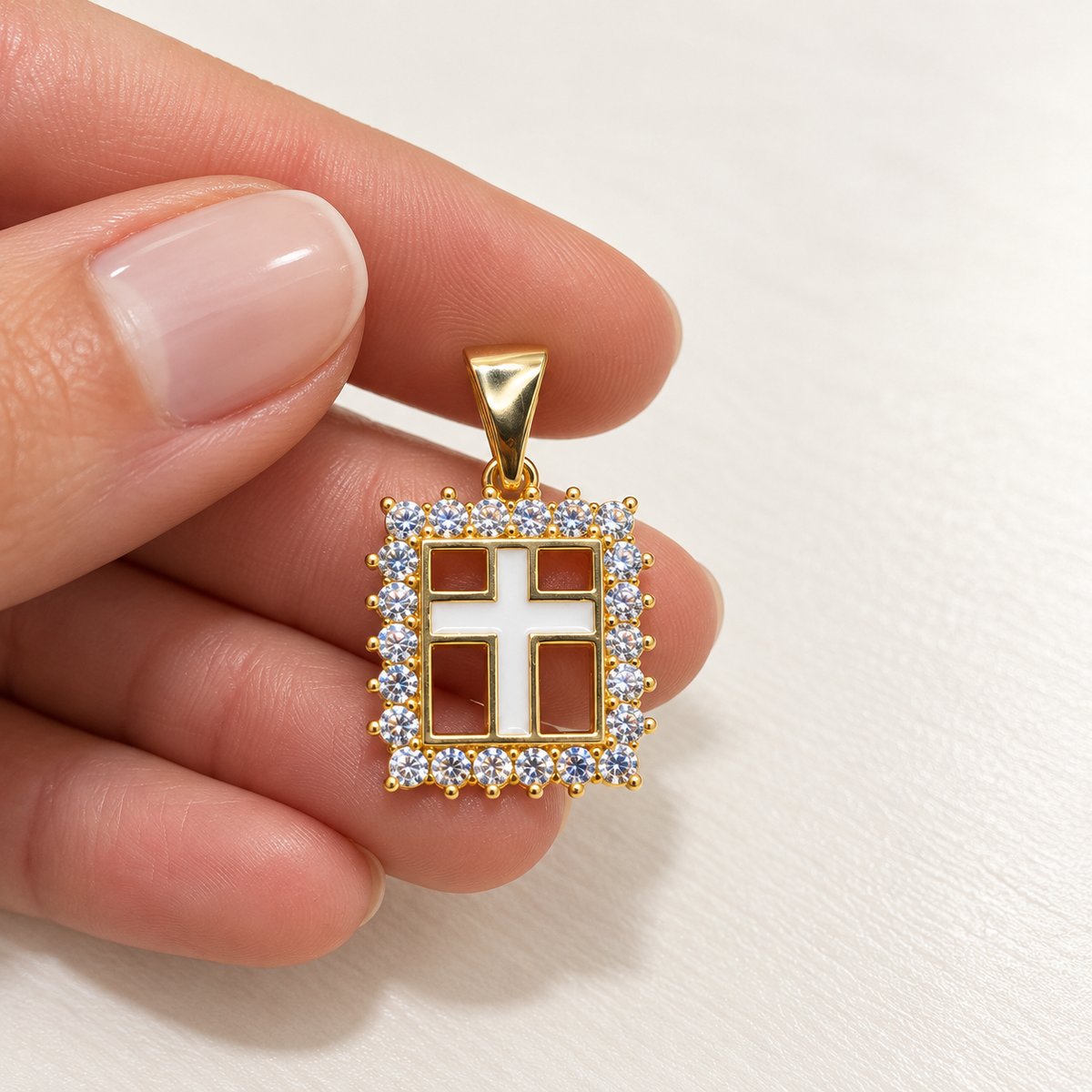 Shop a mother-of-pearl-style cross pendant with a sparkling pave CZ border and an elegant 18K Gold Filled finish.