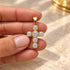 Shop a 18K Gold Filled cross pendant featuring a colorful center stone and sparkling clear CZ accents. Available in multiple stone color options.
