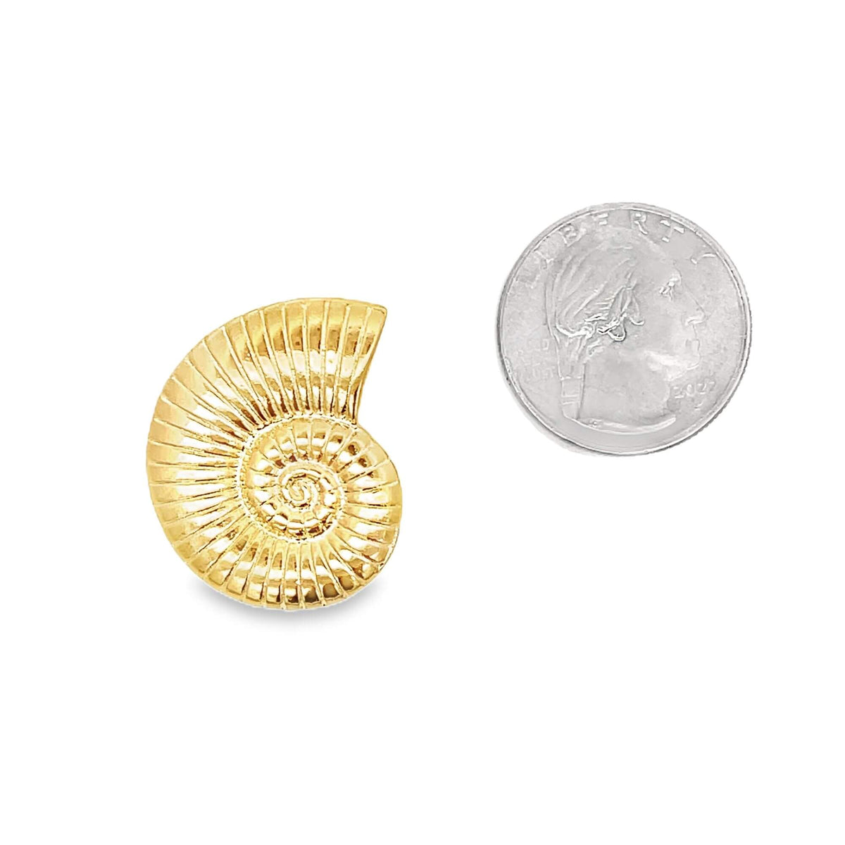 A textured gold ammonite fossil charm sits beside a US quarter for scale.