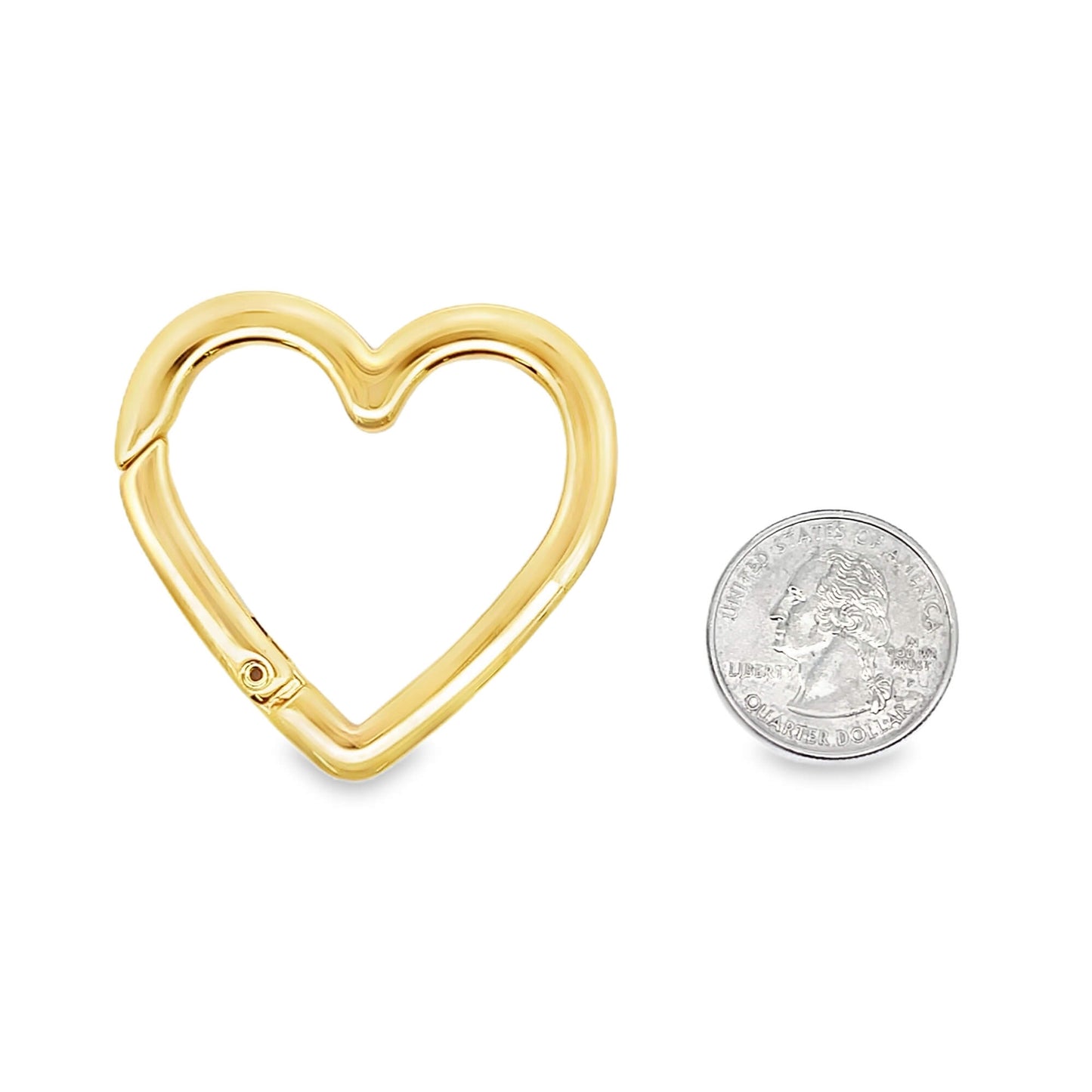 Gold heart-shaped keychain with a quarter for scale on a white background