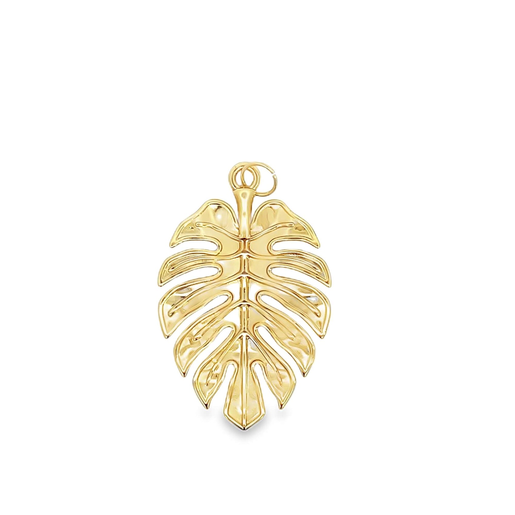 A shiny gold monstera leaf pendant gleams against a clean white background.