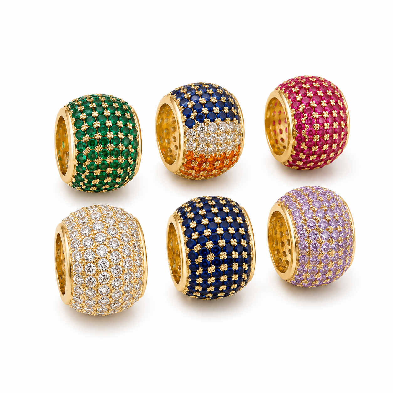 Six colorful gold pavé charm beads sparkle against a clean white background, showcasing green, tricolor, pink, white, blue, and lavender gemstones.