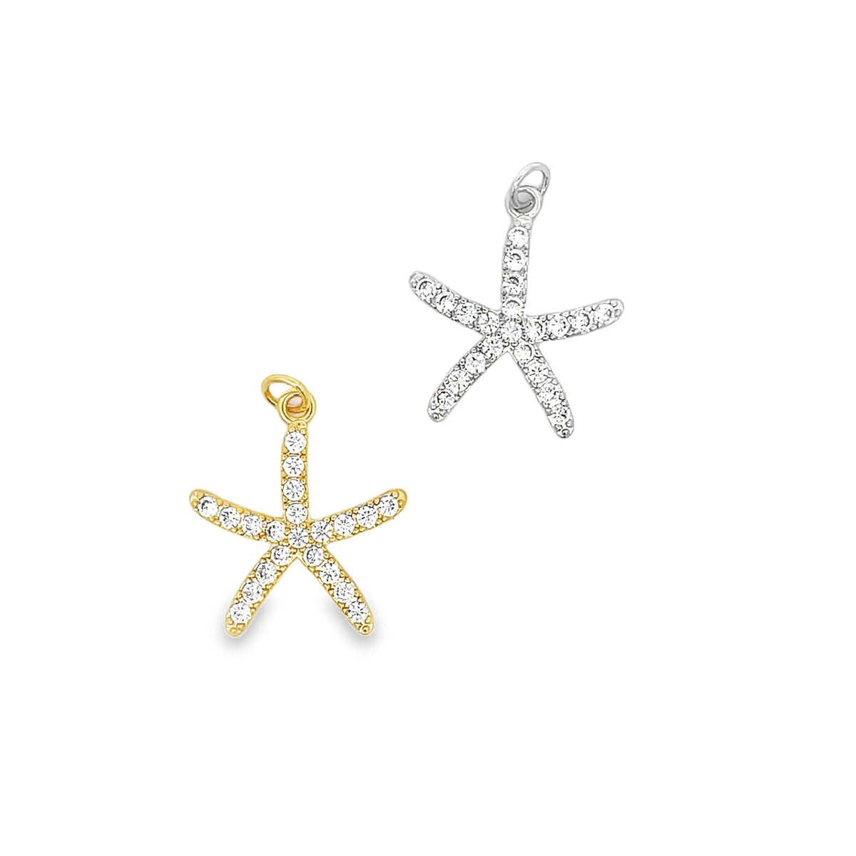 Two pavé-set cubic zirconia starfish charms sparkle in gold and silver against a white background.