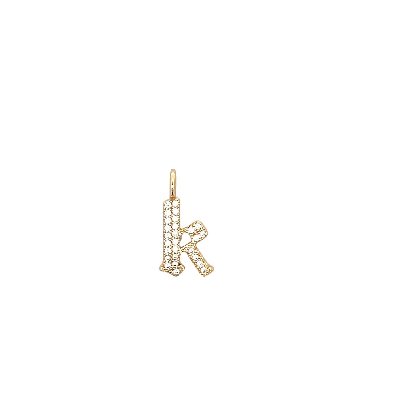 A delicate gold pendant shaped like the lowercase letter k features sparkling pavé-set diamonds.