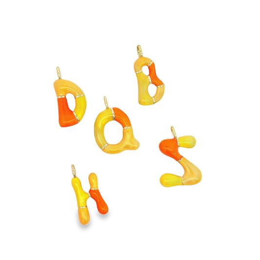Five vibrant orange and yellow enamel alphabet charms featuring letters D, O, B, A, S, and H rest against a white background.