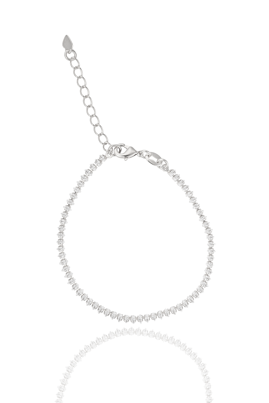 A delicate silver tennis bracelet sparkles against a white background, featuring a lobster clasp and an adjustable chain.