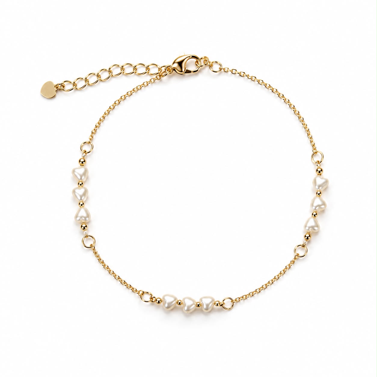 A delicate gold chain bracelet features dainty heart-shaped pearls against a clean white background.