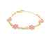 A delicate gold chain bracelet features alternating pink enamel flower charms against a clean white background.