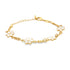 A delicate gold chain bracelet features dainty white enamel daisy charms against a clean white background.