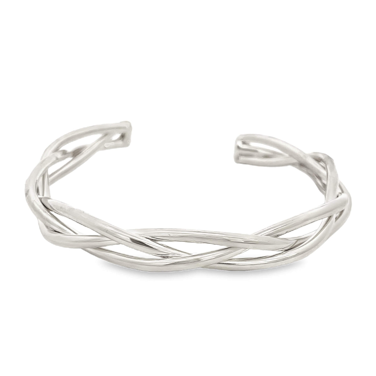 A polished silver cuff bracelet features an intricate design of interwoven metallic strands against a clean white background.