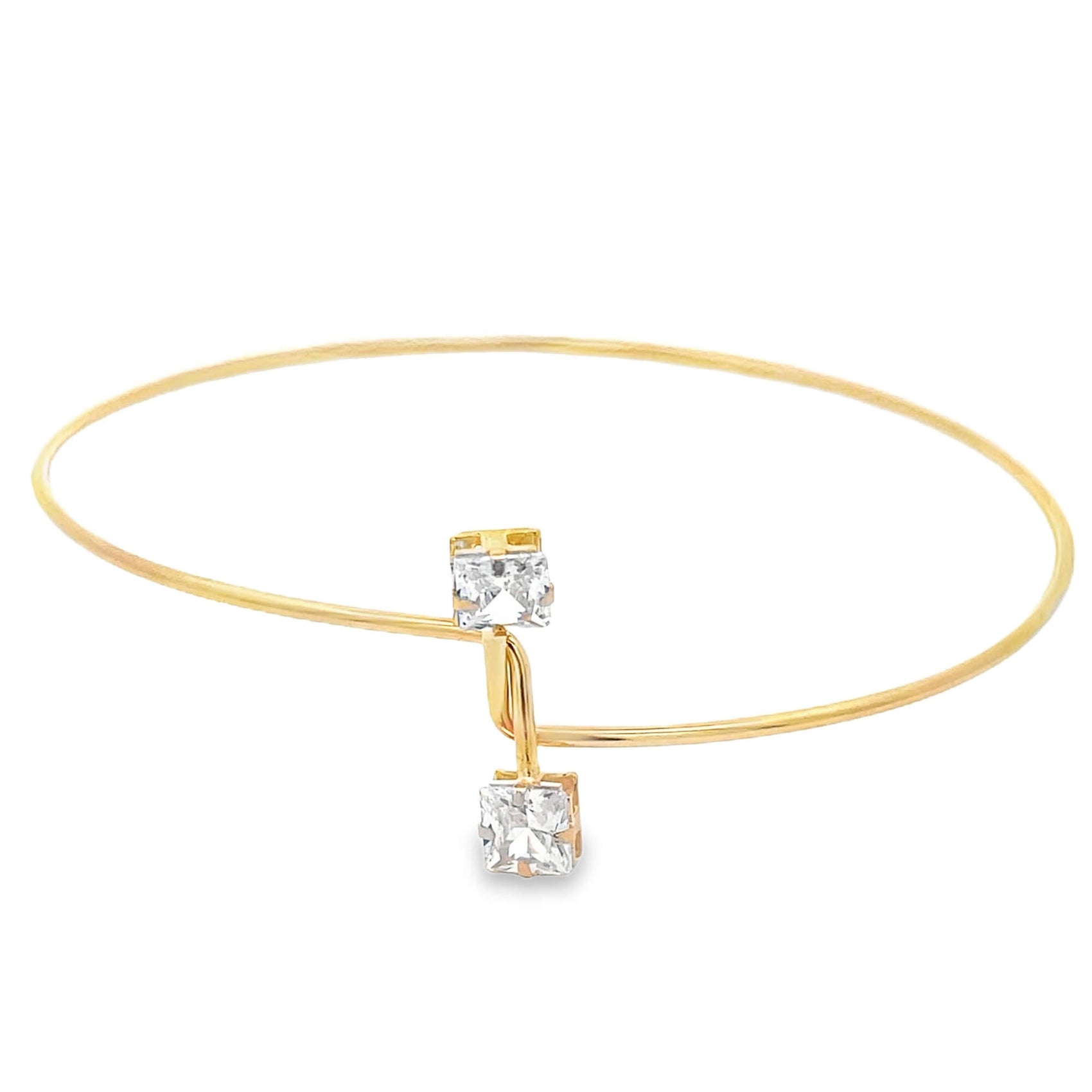 Gold armlet with two square-cut crystals on a white background