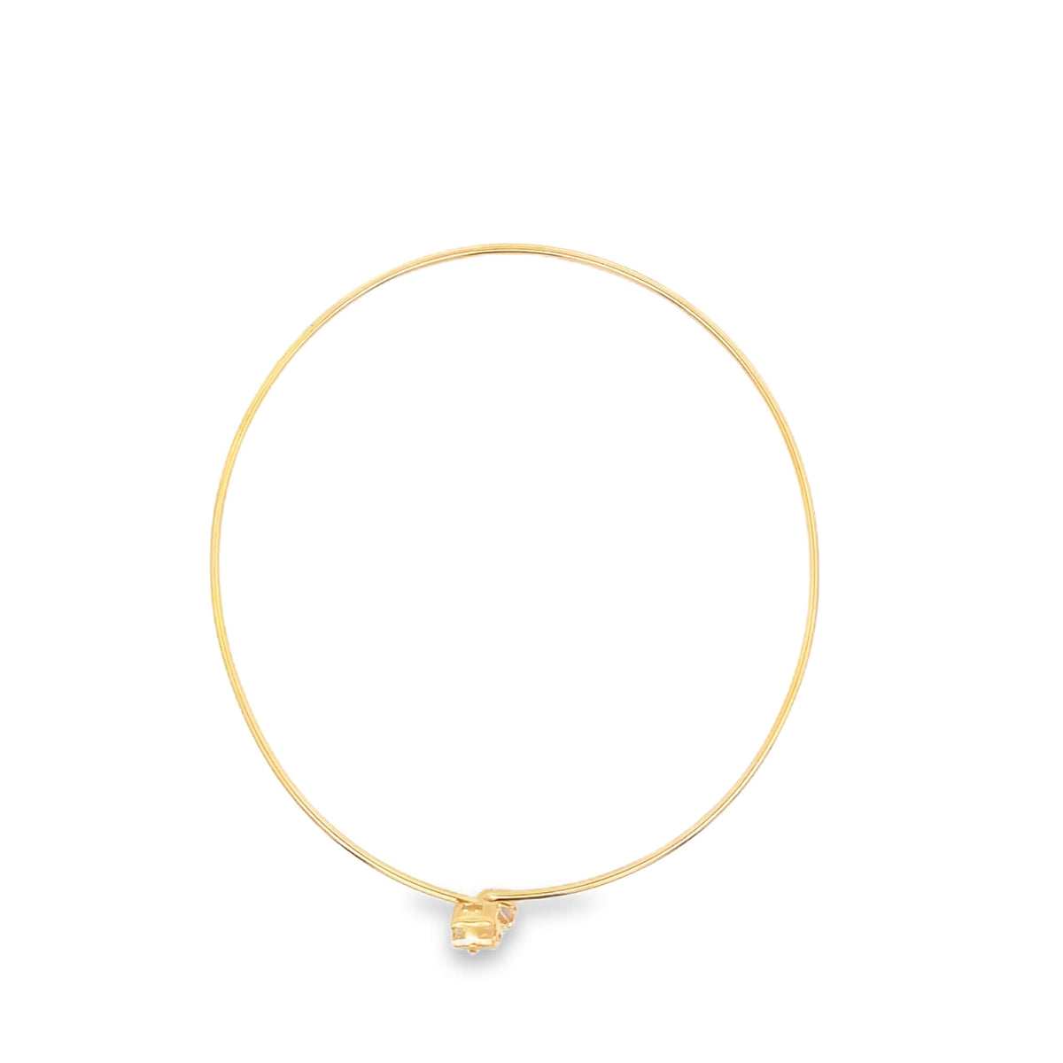 A delicate gold choker necklace rests in a circle on a clean white background, highlighting its minimalist design.