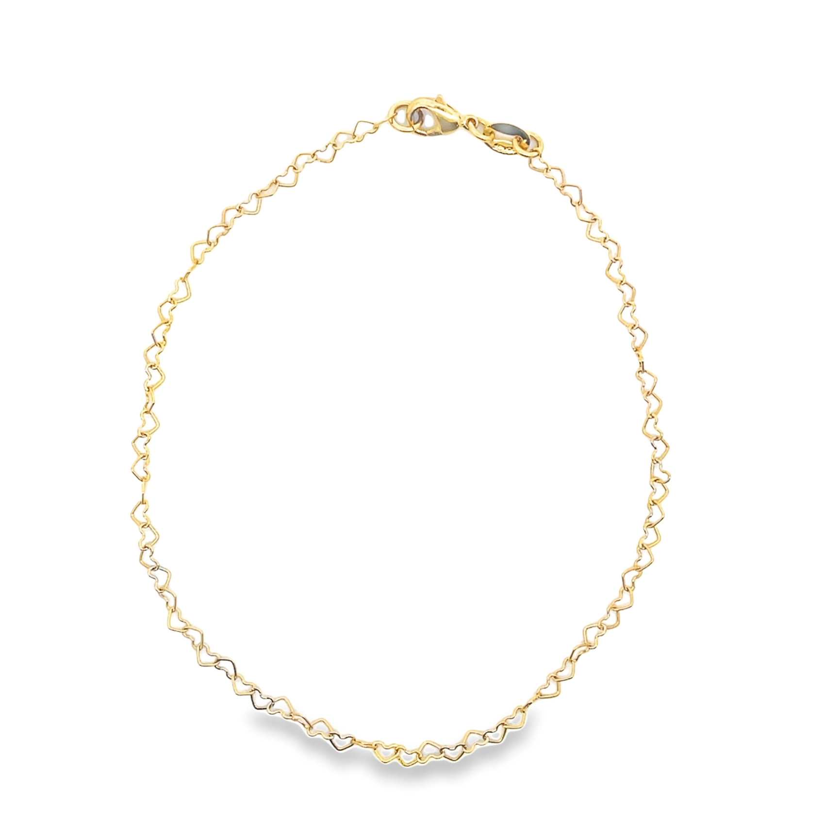 A delicate gold heart-link anklet rests in a circle against a clean white background.