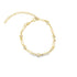 A delicate gold paperclip link bracelet features alternating bezel-set cubic zirconia stones and an adjustable extender chain against a clean white background.