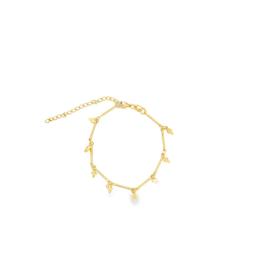 A delicate gold cross charm bracelet rests against a plain white background.