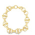A polished yellow gold link bracelet features alternating circular rings and elongated bar links arranged in a circular shape against a plain white background.