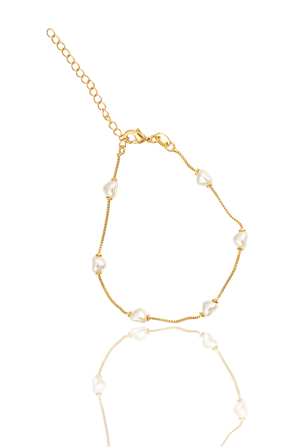 A delicate gold-plated bracelet features spaced white heart-shaped pearls and an adjustable chain clasp against a clean white background.