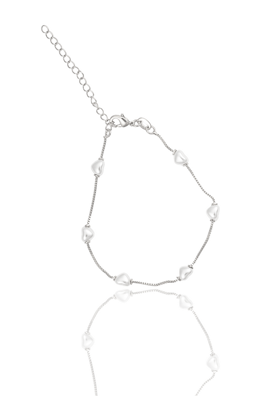 A delicate silver heart charm bracelet features a box chain and a clasp with an extension chain against a clean white background.