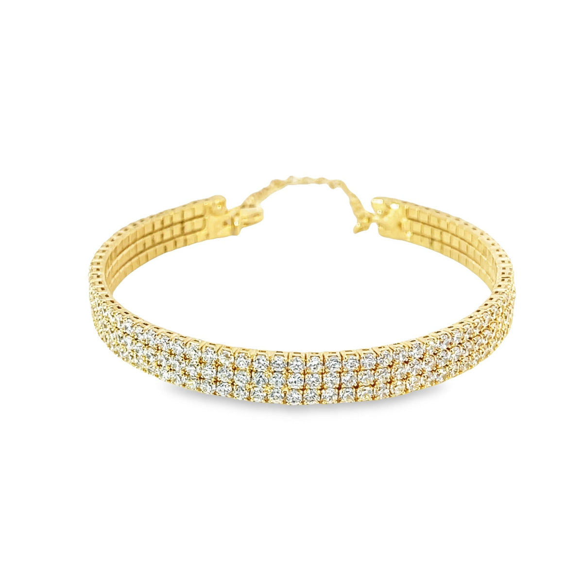 A sparkling triple-row diamond gold bracelet rests against a clean white background.