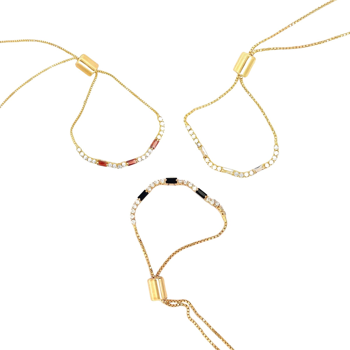 Three delicate gold bolo bracelets feature adjustable sliding clasps and sparkling gemstone accents against a clean white background.