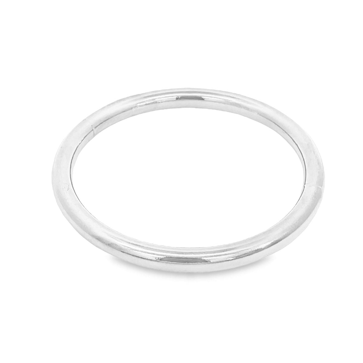 A smooth silver ring lies flat on a clean white background.