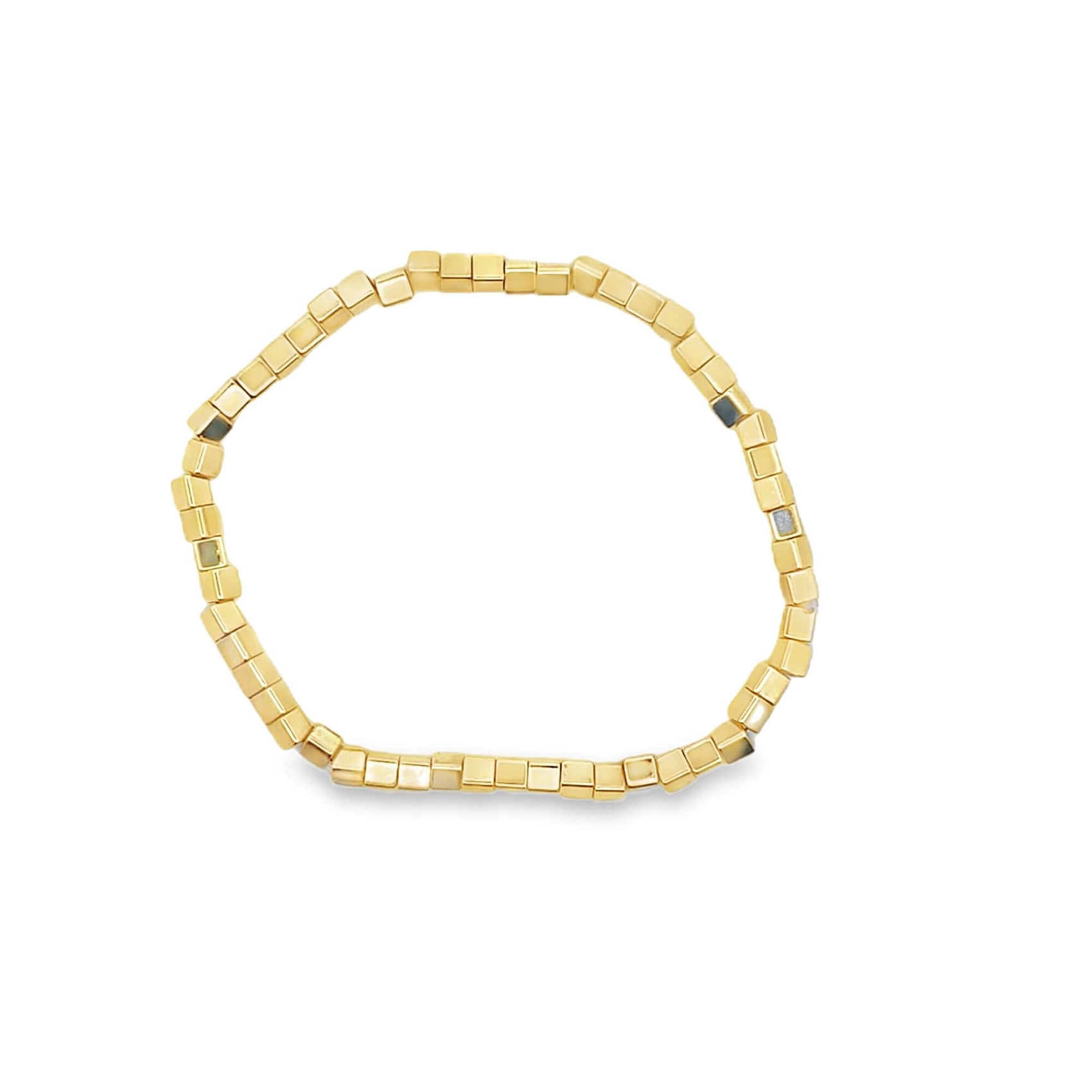 A minimalist gold cube bead bracelet rests against a clean white background.