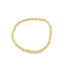 A sleek gold beaded stretch bracelet features alternating round and cube-shaped metallic beads arranged in a continuous circle on a plain white background.