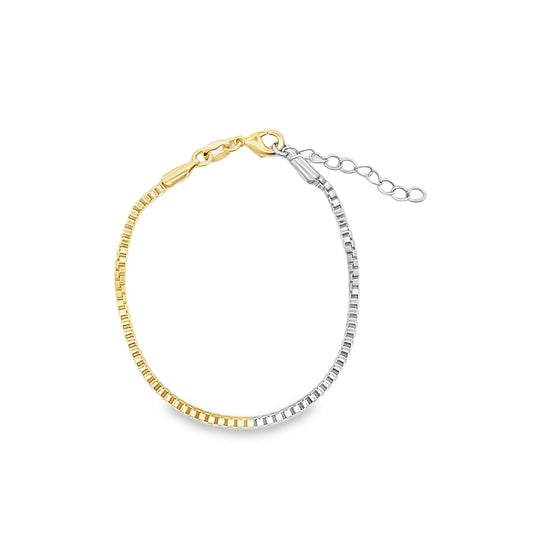 A two-tone box chain bracelet combines yellow gold and silver links with an adjustable clasp against a plain white background.