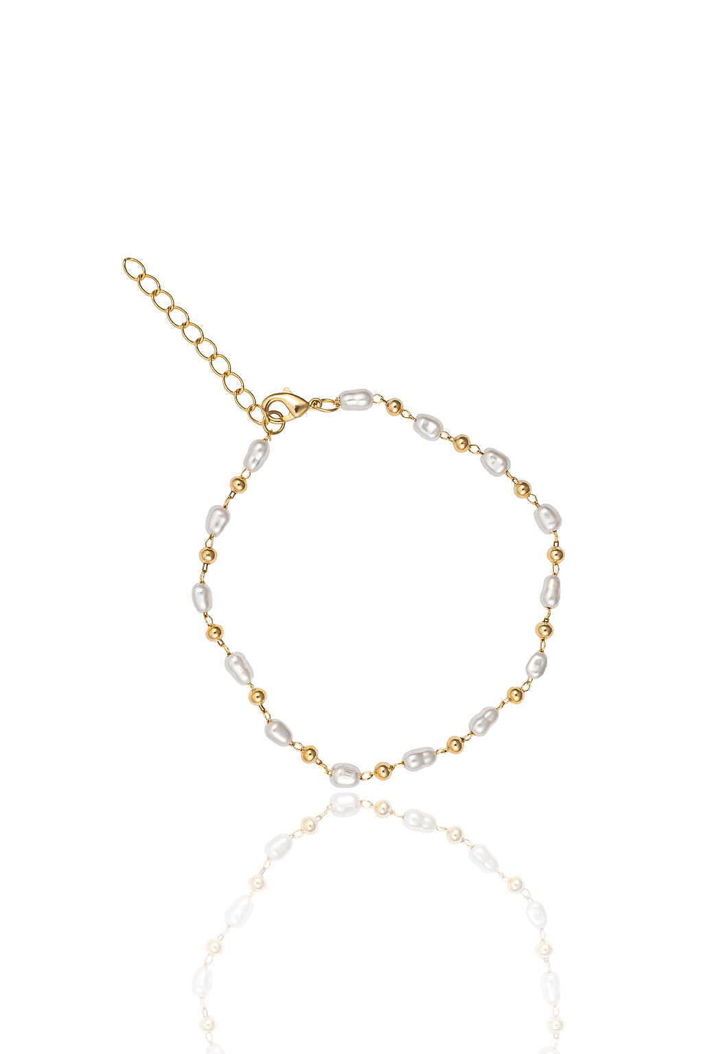A gold beaded bracelet featuring alternating freshwater pearls and small metal beads rests on a white surface with a soft reflection.