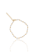 A gold beaded bracelet featuring alternating freshwater pearls and small metal beads rests on a white surface with a soft reflection.