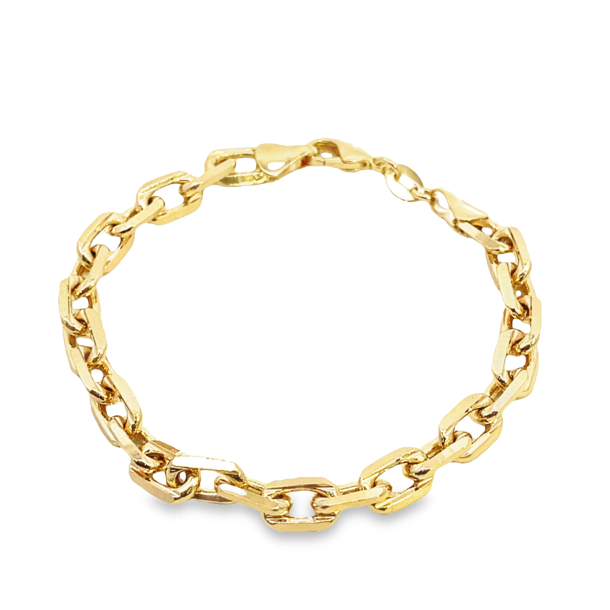 A polished gold link bracelet rests in a circle on a white background.