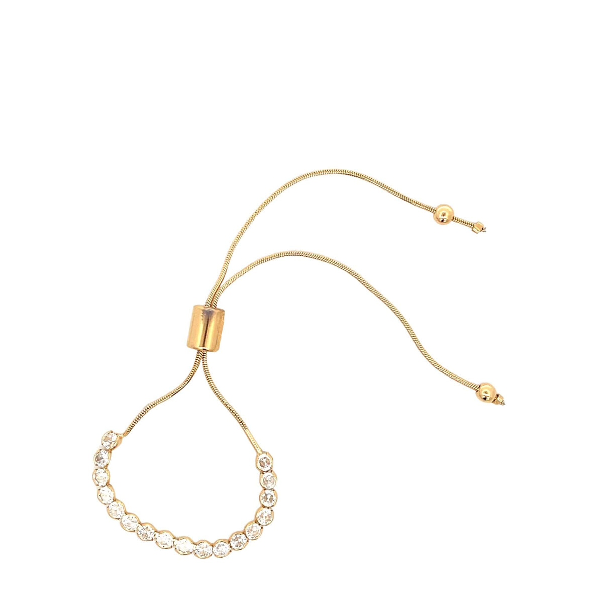 A gold adjustable slider bracelet sparkles with a curved line of round cubic zirconia stones.