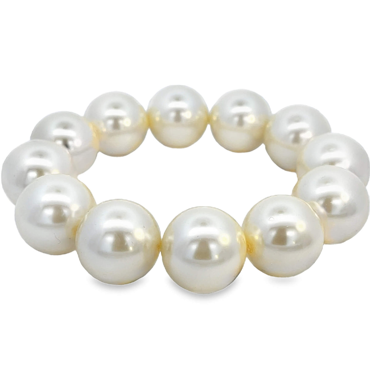 A circular white faux pearl bracelet rests against a clean white background.