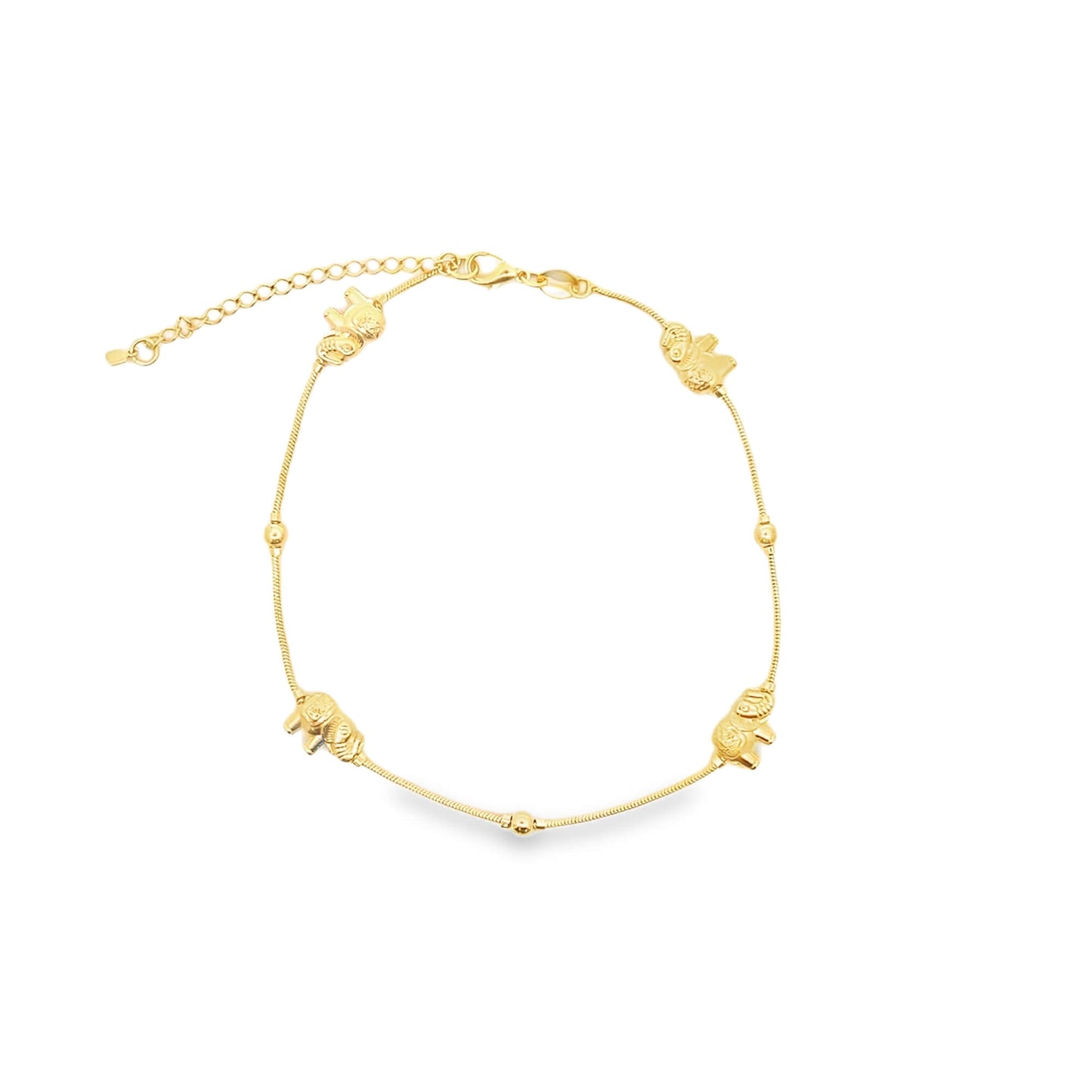 A delicate gold anklet features alternating spherical beads and miniature elephant charms along its chain.
