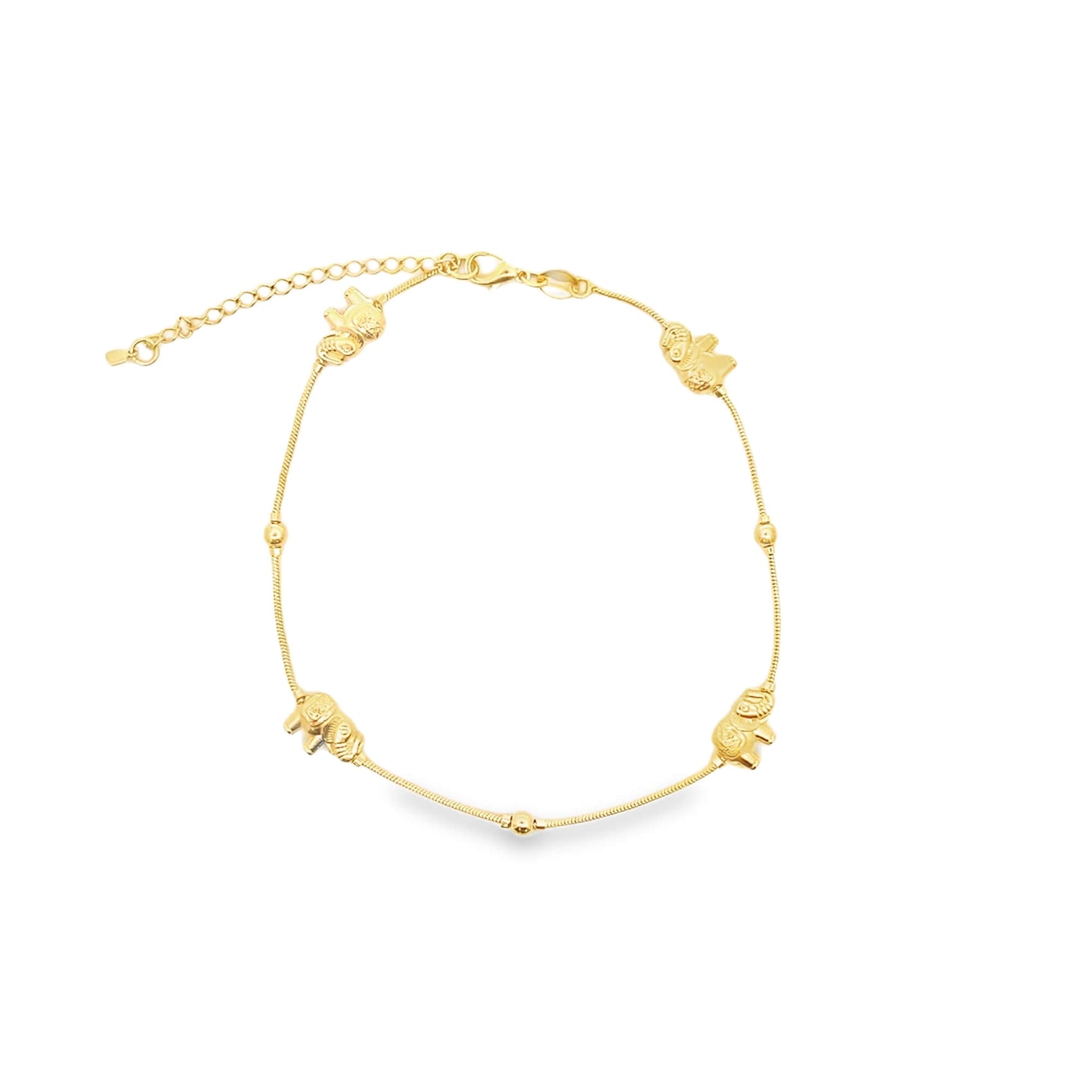 A delicate gold anklet features alternating spherical beads and miniature elephant charms along its chain.