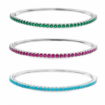 Elegant slim tennis bangle bracelet with sparkling colored CZ stones. Stackable minimalist design available in multiple color options for everyday luxury styling.