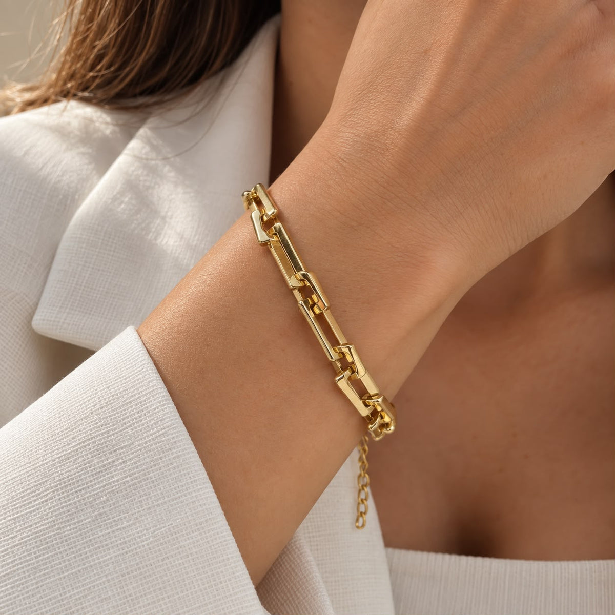 Shop a modern rectangular link bracelet featuring a polished finish and bold contemporary design. Available in 18K Gold Filled and Rhodium Filled finishes.