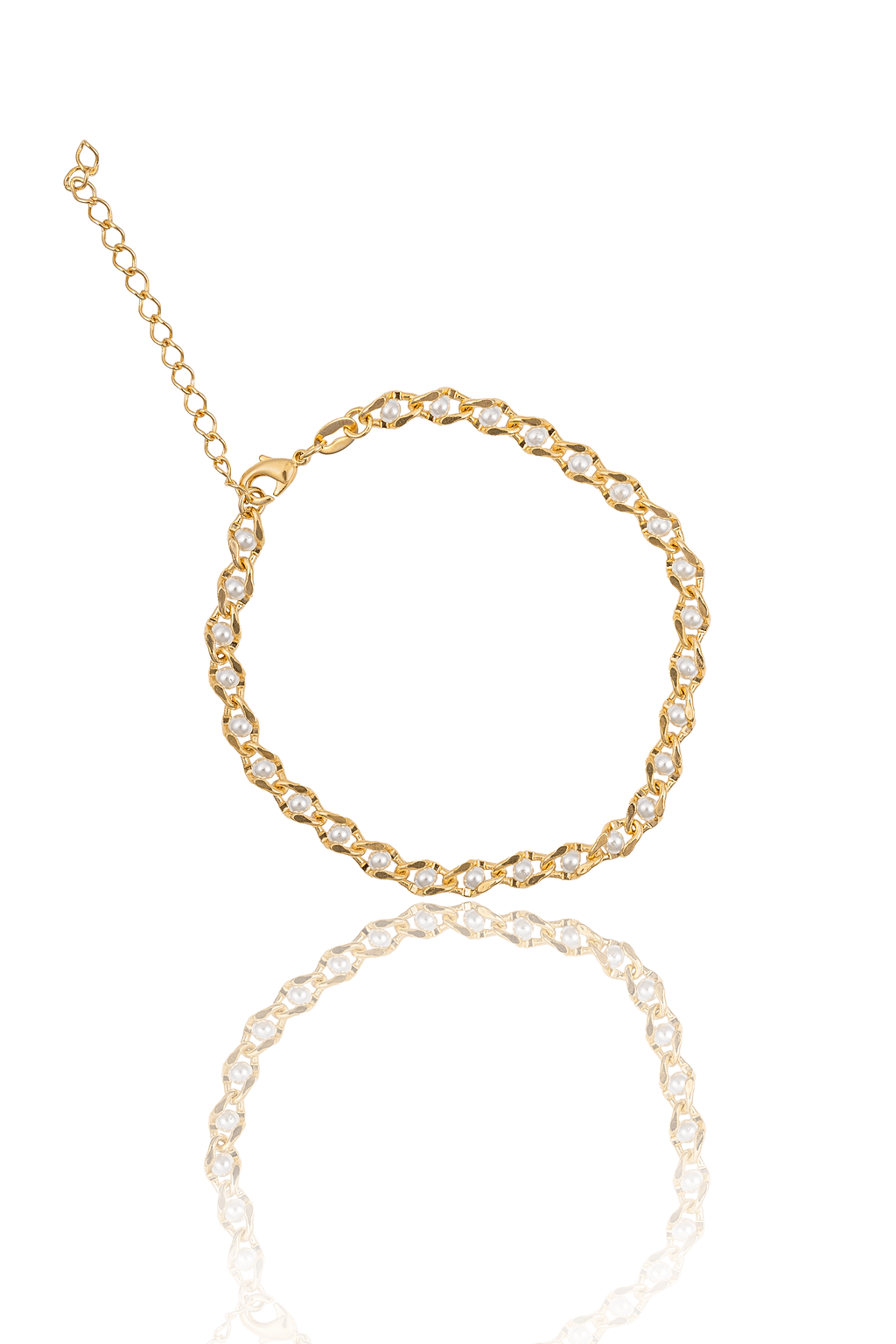 A gold chain bracelet adorned with small pearls lies flat with its reflection on a white surface.